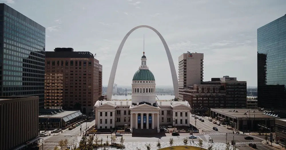 Aerial view of the Gateway Arch and St. Louis cityscape.