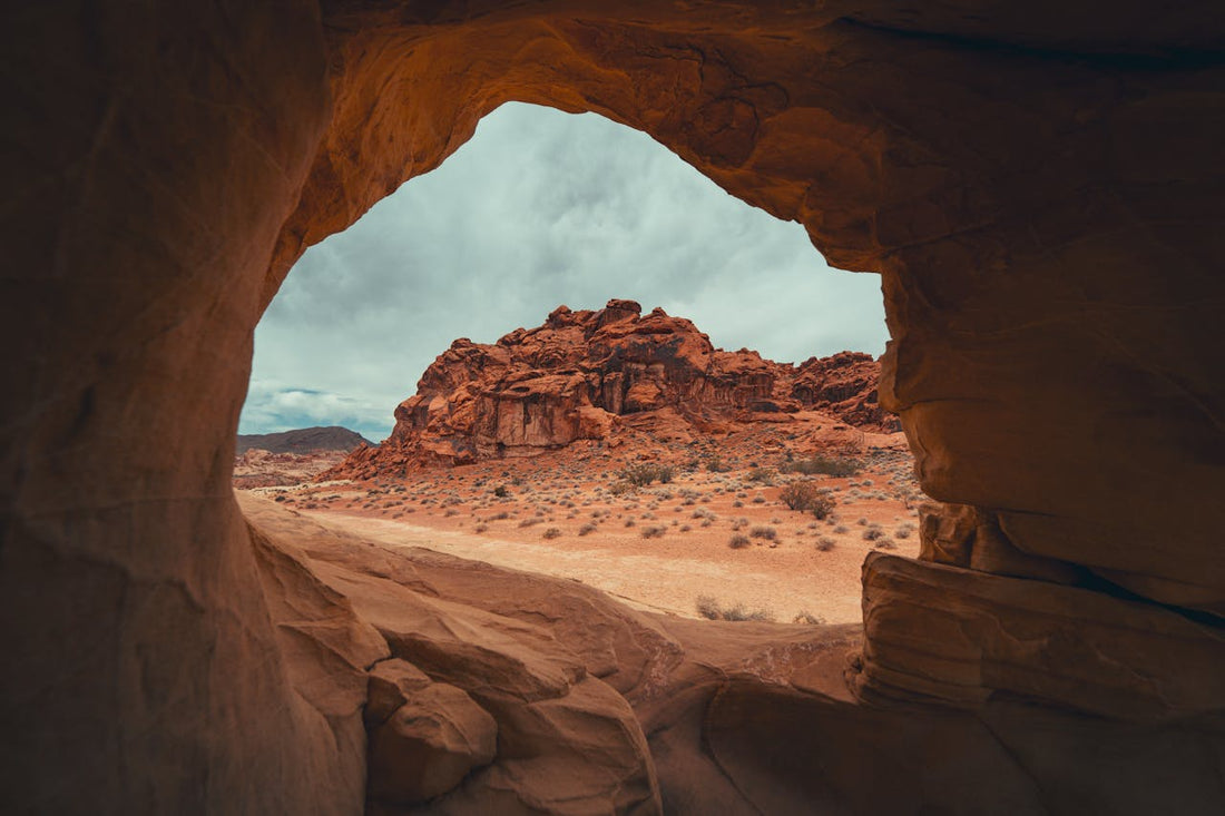 View of a rocky landscape through a natural arch