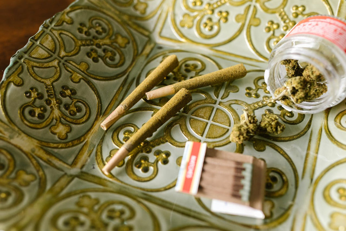 Cannabis pre-rolls and a jar of cannabis on a decorative plate