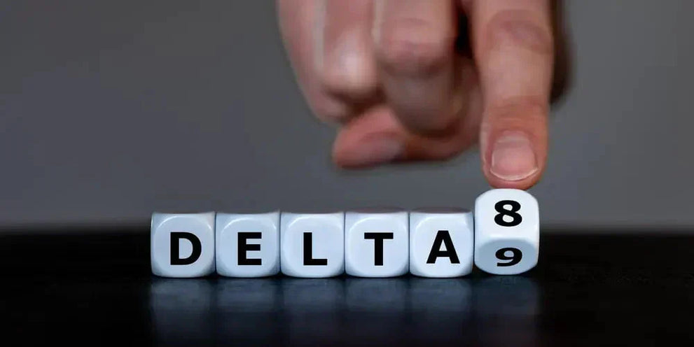 A hand pointing at a die showing the number 8 in the word DELTA