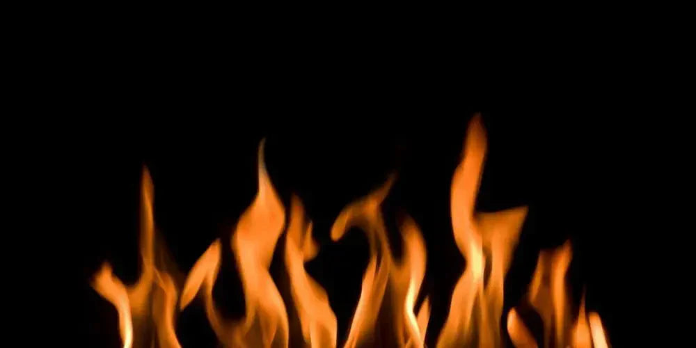 Flames against a black background, representing heat in decarboxylation process.