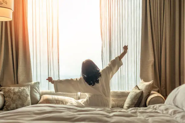 A Woman Wakes Up Refreshed After Taking The Best THC Edibles For Sleep
