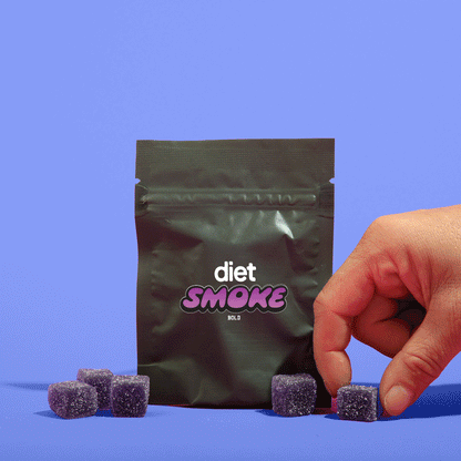 A hand reaching for purple gummies from a Diet Smoke package against a blue background.