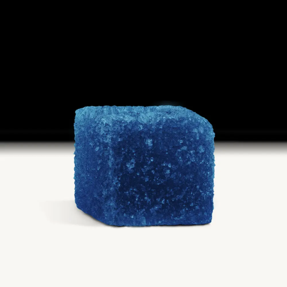 Blue Boomers gummy, a blue cube-shaped candy with a sugar coating, featuring Amanita and THC for a euphoric experience.