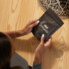 A person holding a black package of Cherry Lime Gummies with the label 'diet SMOKE' visible.