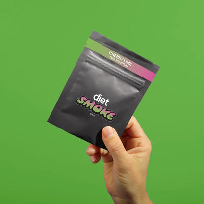 Hand holding a black package labeled 'Cherry Lime' from Diet Smoke