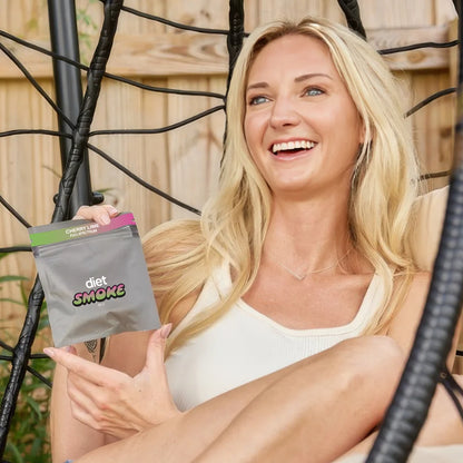 A woman holding a package of Cherry Lime Gummies with CBD, smiling while sitting in a hanging chair.