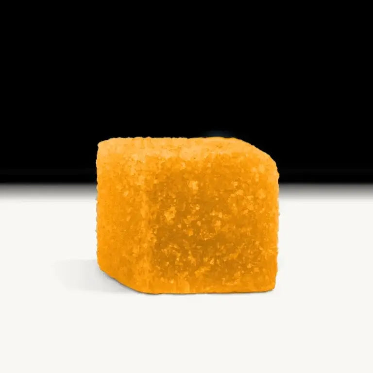 Orange Creamsicle gummy candy on a black background